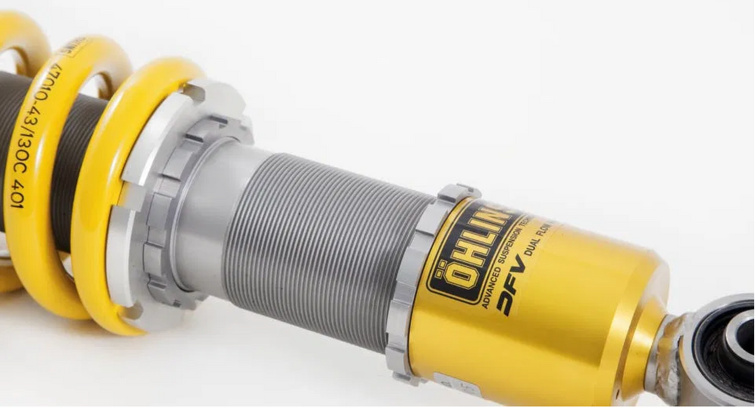 Ohlins coilover showing the threaded section and logo.